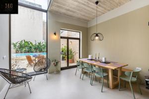 a dining room with a wooden table and chairs at Ultimate Luxury Home experience in Beautiful Rabat by 360 Estates in Rabat