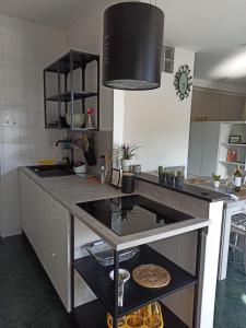 a kitchen with a counter with a stove top oven at Il Glicine appartamento vacanze, non solo mare! in Casarza Ligure