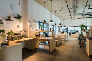 a large office with tables and chairs and people at Nena Hostel Berlin in Berlin