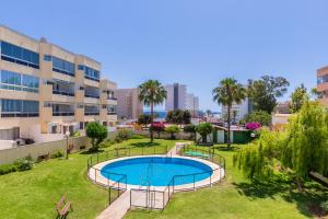 an apartment with a swimming pool in a yard at Vistamarina B201 By IVI Real Estate in Torremolinos