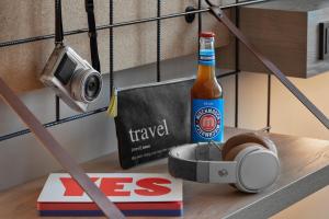 a bottle of beer and a camera on a table at Moxy Duesseldorf City in Düsseldorf