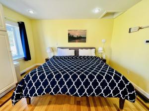 a bedroom with a bed with a black and white comforter at New Buffalo Inn in New Buffalo +6 photos