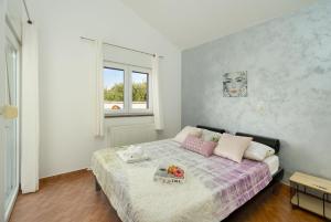 a bedroom with a bed with a tray on it at House Leonardo in Galovac