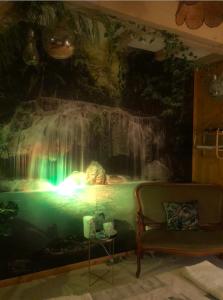 a room with a waterfall mural on the wall at Chambre d'hôte txaleta (le Chalet) in Saint-Priest-sous-Aixe