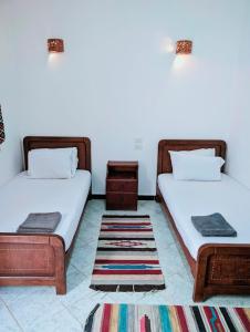 two beds sitting next to each other in a room at Ghazala Oasis Dahab in Dahab