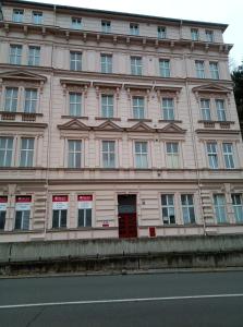 a large pink building with a red door at Kamil Apartments, Delux A, 65m2 in Karlovy Vary