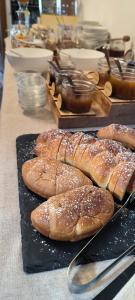 a group of breads on a black plate on a table at Zimmervermietung Gröberhof in Schenna