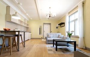 a kitchen and living room with a couch and a table at Verona Apartments - Paide in Paide