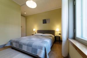 a bedroom with a bed and a large window at Verona Apartments in Paide