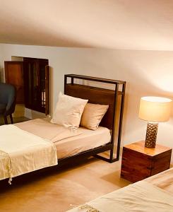 a bedroom with two beds and a lamp and a bed sidx sidx sidx at Guesthouse Corte Marzago - adults friendly in Salionze