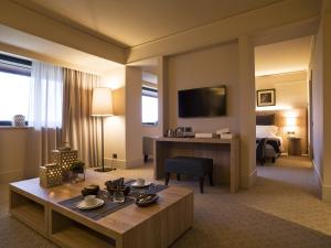 a hotel room with a hotel suite with a desk at A.Roma Lifestyle Hotel in Rome