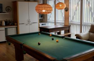 a kitchen with a pool table in a living room at Casa de Encosturas in Cabeceiras de Basto