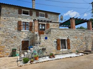 a stone house with a bike parked outside of it at Apartment Paulina in a Stone House in Jakići
