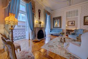 a living room with a fireplace and blue curtains at Palácio das Especiarias in Lisbon