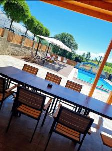 a table and chairs and a swimming pool at Soba pri nam in Gačnik +6 photos