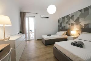 パレルモにあるLa Casa di Aleのベッド2台とバルコニーが備わるホテルルームです。