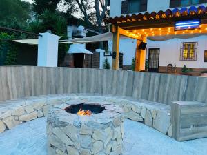 a stone fire pit in front of a fence at MASIA LA MOLINERA in Xerta