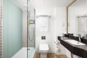 a bathroom with a sink and a toilet and a shower at Holiday Inn Leeds-Wakefield M1 Jct40, an IHG Hotel in Wakefield