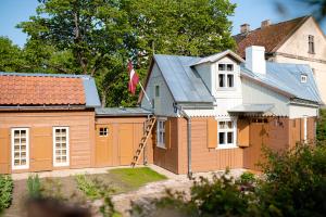 a house with a garage and a house with a flag at i’dille Brīvdienu māja in Kuldīga