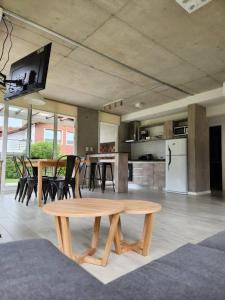 a living room with a table and a kitchen at Complejo 42 in Mar Azul +12 photos