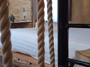 a bedroom with a bed with ropes around it at Dimora 421 Apartsuite in Chioggia