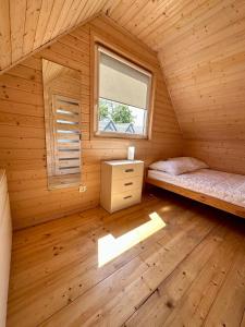 a room with two beds in a log cabin at Słoneczna Laguna in Sarbinowo