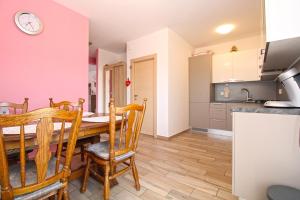 a kitchen and dining room with a table and chairs at House Volme 2255 in Banjole