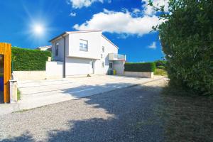 a white house with the sun in the sky at House Volme 2255 in Banjole