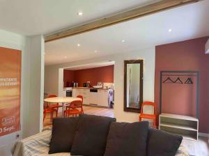 a living room with a couch and a table at La maison du jardin in Douai