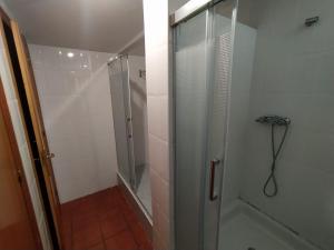 a shower with a glass door in a bathroom at Albergue de Nuestra Señora Carrasquedo in Grañón