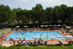 a large swimming pool with many people in it at Camping Badiaccia Village in Castiglione del Lago