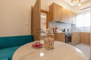a kitchen with a table with a jar of fruit on it at Perfect Living in Rhodes Town