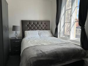 a bedroom with a large bed with a window at 1 Bed Central Newark Flat 1st Floor in Newark-on-Trent