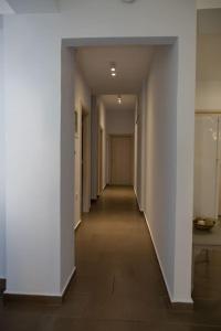 an empty hallway with white walls and a long hallway at Sweet Home near Patras in Patra