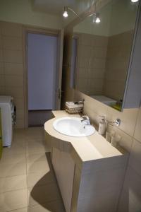 a bathroom with a sink and a mirror at Sweet Home near Patras in Patra