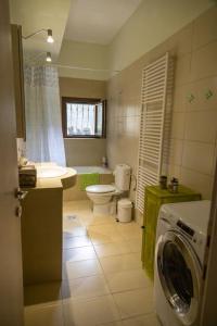 a bathroom with a washer and a washing machine in it at Sweet Home near Patras in Patra