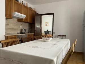 a kitchen with a table with a bowl of fruit on it at Casa Rosalina Sardinia Italy in Luogosanto +11 photos