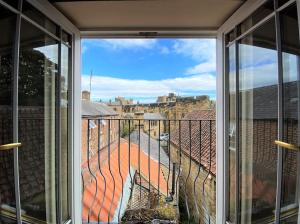a view from the window of a balcony at Stunning 3 bedroom House with amazing Castle view in Alnwick