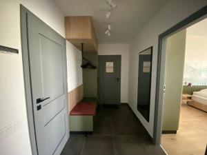 a hallway with two doors and a red carpet at Angyal Villa in Rátka