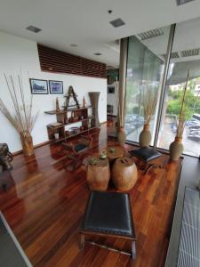 a living room with wooden floors and vases at Bosmal Arjaan by Rotana in Sarajevo