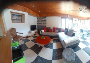 a living room with a couch and a table at La colline de pam la belle vue in Cornimont