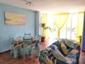 a living room with a table and a couch at Blue Wave House Corralejo in La Oliva +25 photos