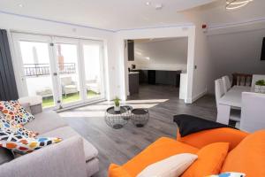 a living room with a couch and a table at Luxury town apartment with roof terrace, Sleeps 6 in Blackpool