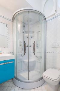 a glass shower in a bathroom with a toilet at La Terrazza Amalfi in Amalfi