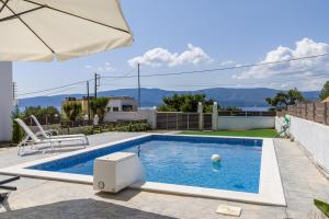 a swimming pool in the backyard of a house at Modern, Cheerful & Dream Catching Villa in Corinth in Isthmia