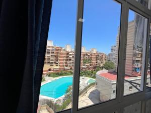 uma vista para uma piscina a partir de uma janela em VIS3 - Estudio con Wifi, Centro a 200 metros, Playa a 850 metros em Torremolinos