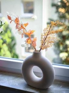 a grey vase with flowers in it on a window sill at 75qm Luxusapartment in perfekter Lage in Bochum