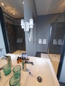 a bathroom with a sink and a mirror at La Fraîchette-Hôtel & Spa in Honfleur