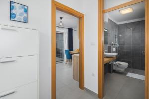 a bathroom with a toilet and a sink at Apartments Špadići in Poreč