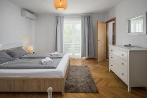 a bedroom with a bed with two towels on it at Apartments Špadići in Poreč